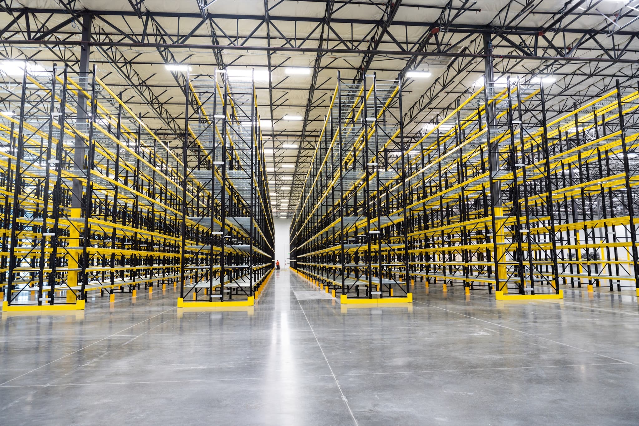 Warehouse aisle with pallet racking stretching into the distance
