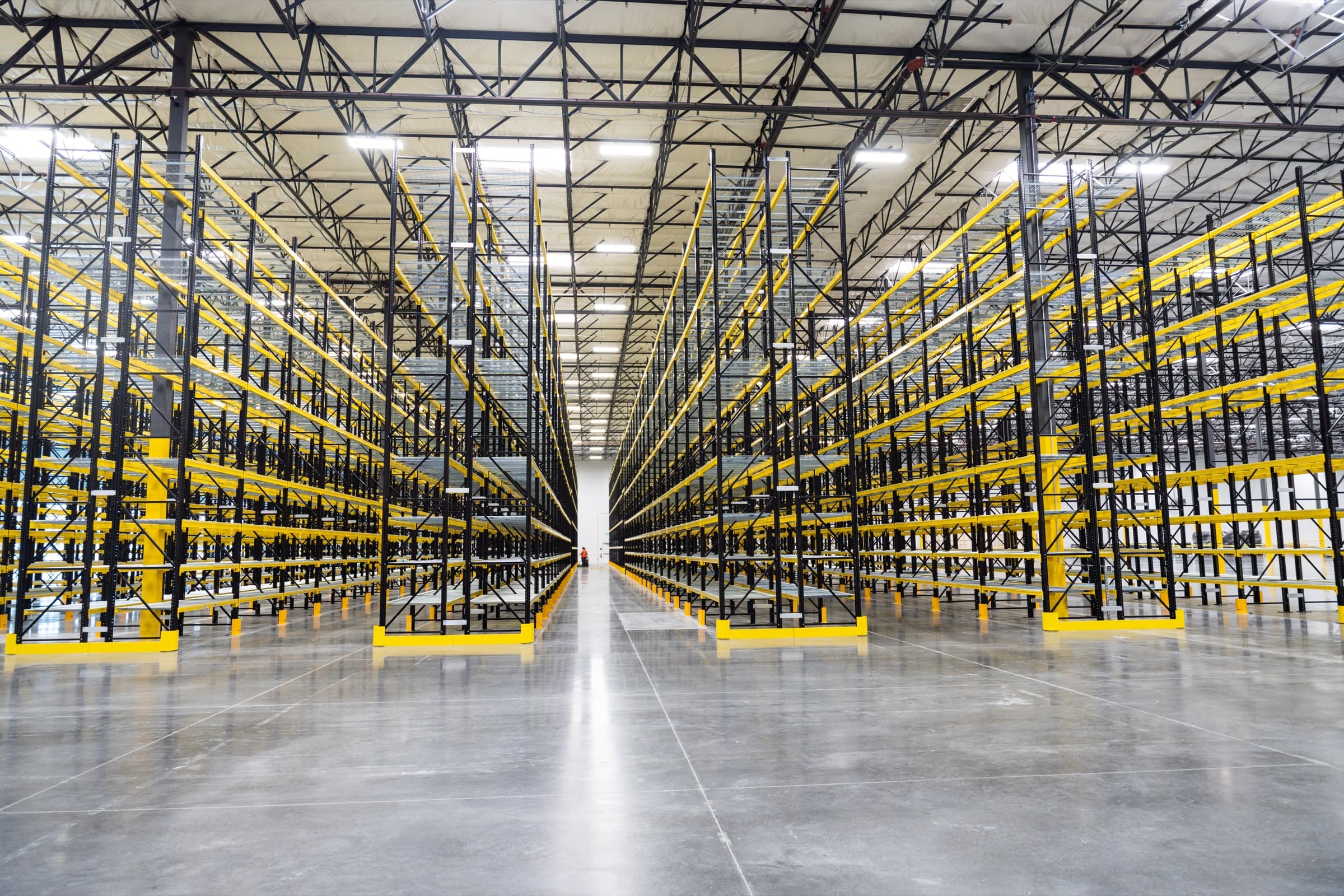 Warehouse aisle with pallet racking stretching into the distance