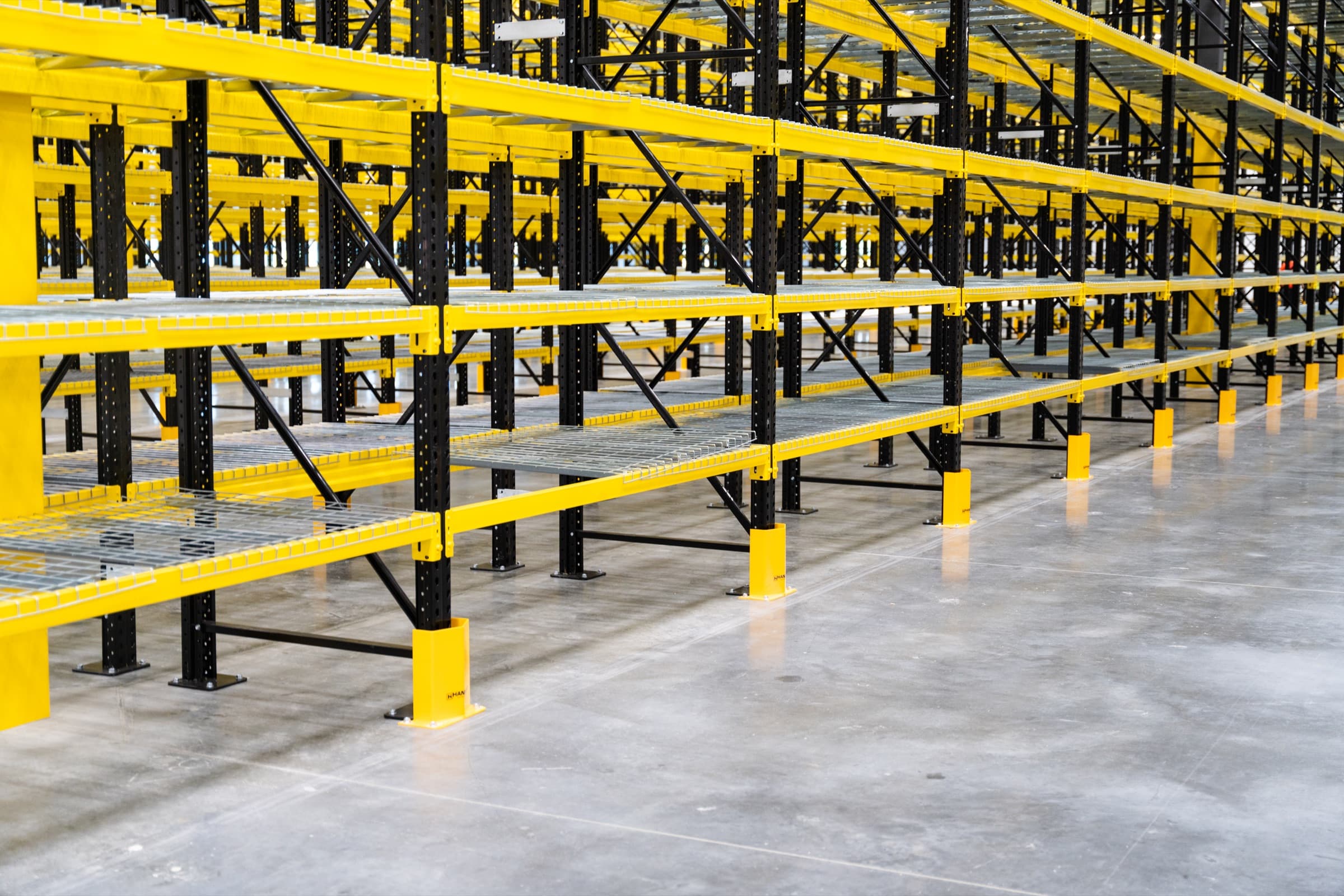 Close-up of pallet rack beams, wire decking, and column protectors